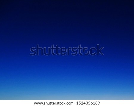 blue background. The clear sky during sunrise in the morning. no cloud in the sky and the the sky is deep blue to light blue and light yellow Royalty-Free Stock Photo #1524356189