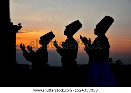 whirling Sufi dance in silhouette Royalty-Free Stock Photo #1524359858