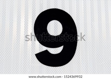 Number 9 with white textured background.