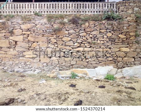 Sakrai, Rajasthan/India-Oct 07, 2019: Stone wall without cement. This picture is of the wall of a village in the Aravalli ranges.