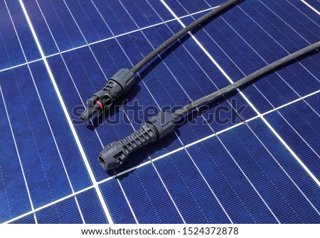 Solar PV Connectors Male and Female laid on Solar Panel Surface