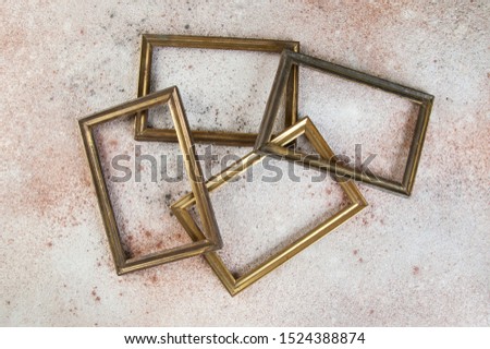 Four old empty picture frames on concrete background. Photography props and copy space for text.  