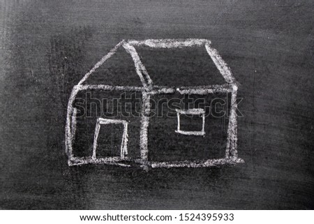 White color chalk hand drawing in home shape on blackboard background