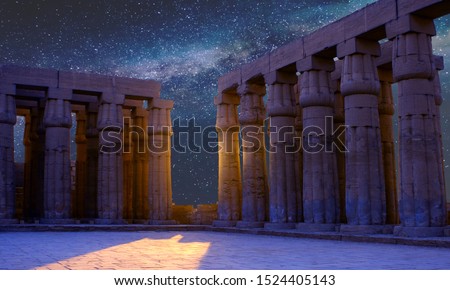 Karnak Temple, The ruins of the temple, Embossed hieroglyphs on the wall. The night sky. Royalty-Free Stock Photo #1524405143