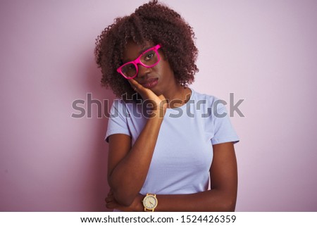 Young african afro woman wearing t-shirt glasses over isolated pink background thinking looking tired and bored with depression problems with crossed arms.
