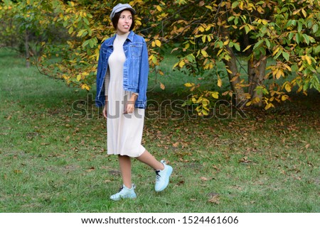 beautiful woman walks in the park in autumn