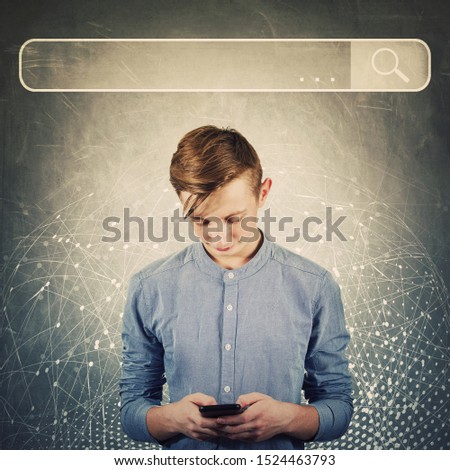 Curious teenager boy using his mobile phone browsing network search bar to find useful information and data. Internet searching engines, modern technology, virtual life and networking concept.
