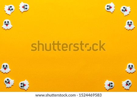 Halloween holiday concept, Spooky ghosts in orange background with copy space for text, Top flat view wallpaper