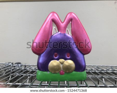 Ceramic and painted easter bunny with green, purple and pink