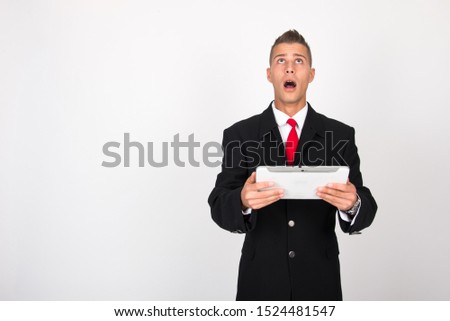 Handsome attractive smiling happy joyful young casual businessman male using tablet isolated on the white background, millennial modern working, gadget online data and information business concept
