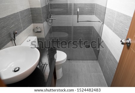 Shower cabin with a glass walls and door in a modern bathroom.