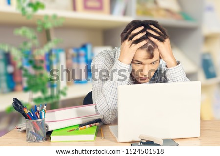 Frustrated black male student work at laptop get mad having device software operational problems, angry african American guy man feel confused with slow internet connection on computer or virus attack Royalty-Free Stock Photo #1524501518