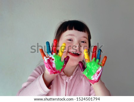 Cute little girl with painted hands. Isolated on grey background. Royalty-Free Stock Photo #1524501794