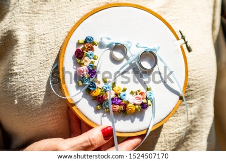 Close-up view of golden wedding rings on decorative stiching ring pillow Royalty-Free Stock Photo #1524507170