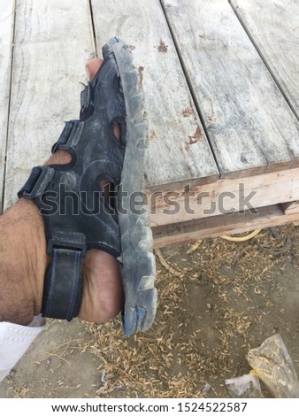 picture of a shoe with foot and the shoe is black in color
