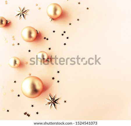 Christmas background. Xmas or new year gold color decorations on pink background with empty copy space for text.  holiday and celebration concept for postcard or invitation. top view 
