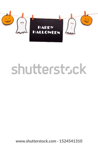 Creative Happy Halloween text hanging out on rope with funny paper figures on white, copy space, vertical panorama
