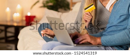 Internet Banking. Unrecognizable Couple Using Laptop And Credit Card Shopping Online Sitting On Couch At Home. Selective Focus, Cropped