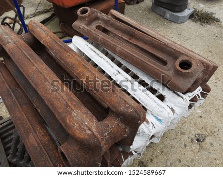 Old cast-iron battery. Vintage rusty battery section photo