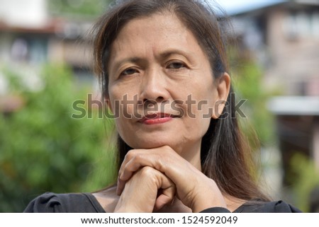 A Serious Filipina Female Senior Royalty-Free Stock Photo #1524592049