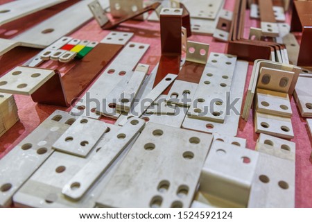 Rectangular metal plates with round holes. Electrical products, connecting elements of power electrical equipment.