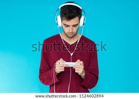 young man with headphones isolated on color background