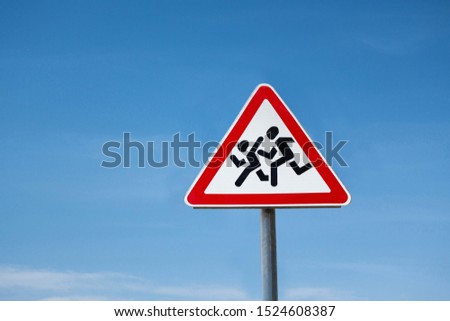 International traffic sign 'Children crossing' on blue sky background