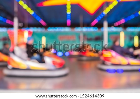 Blurred photo as background of bumper cars at an amusement park in city theme park. Royalty-Free Stock Photo #1524614309
