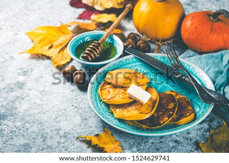 Pumpkin pancakes on rustic stone background, copy space