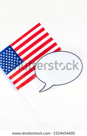 Creative top view flat lay of American flags for Elections, Memorial Day, 4th of July or Labour Day with bubble lightbox mockup with copy space white background. Concept of patriotism and independence