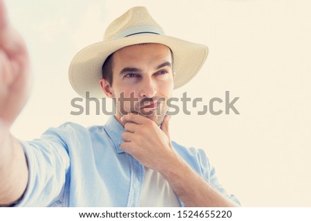 Selfie pensive man in a hat, portrait, toned