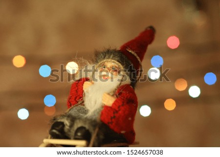 santa on the wooden sledge with christmas lights on background
