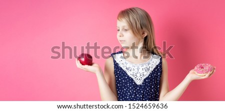 A picture of young girl choosing between red apple and donut