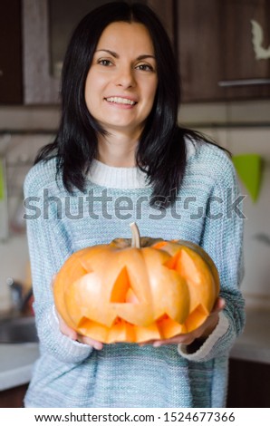 Girl holding a pumpkin for halloween. Halloween concept