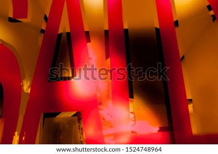 The word sale in the window with the mannequins. Abstract composition