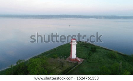 lighthouse. lighthouse on the river. photo from the air. on the background of the river. lighthouse at dusk
