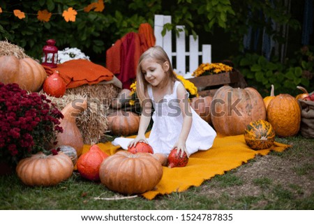 Little cute adorable girl with pumpkin outdoor 
