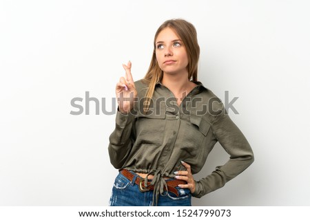 Lithuanian blonde girl over isolated white background with fingers crossing and wishing the best