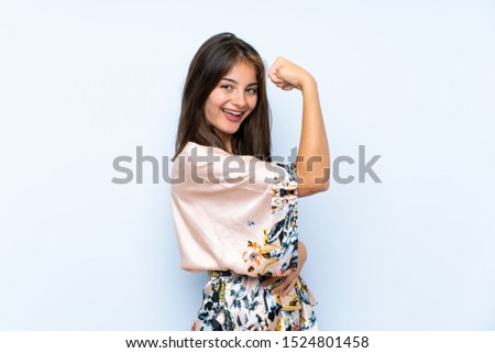 Caucasian girl with kimono over isolated blue background making strong gesture