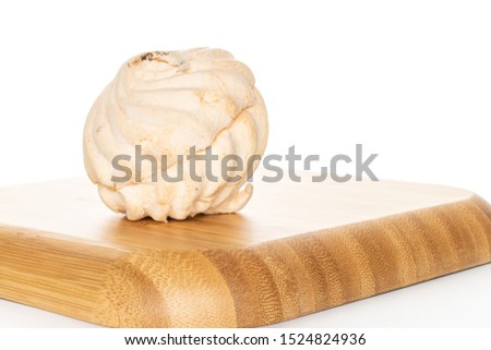 One whole apricot fresh pastel zefir on wooden square plate isolated on white background