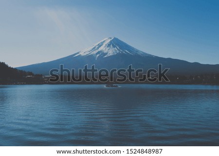 Boat Cruising On Yamaguchi Lake With mount Fuji in Background