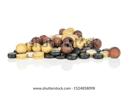 Lot of whole colorful wooden bead heap isolated on white wood