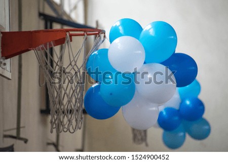 Balloons hanging near a basketball hoop