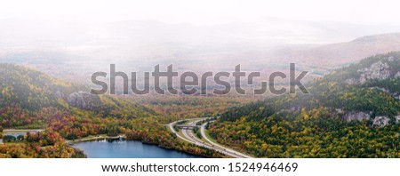 Franconia Notch State Park scenic view from Canon Mountain with Echo Lake and highway on foggy fall day Royalty-Free Stock Photo #1524946469