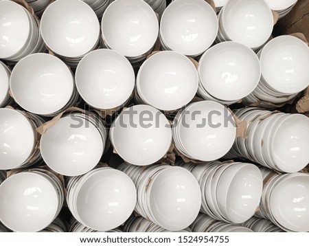 Top view of white round ceramic porcelain bowls in stocks for sales in the market. Production and ceramic industry concept