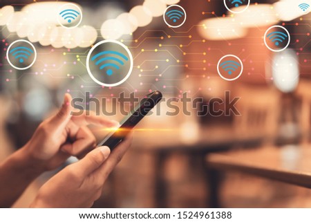 Woman hand using smart phone with wifi icon and line dot abstract background at coffee shop colorful bokeh light. Technology business and modern lifestyle concept. Vintage tone filter effect color. Royalty-Free Stock Photo #1524961388