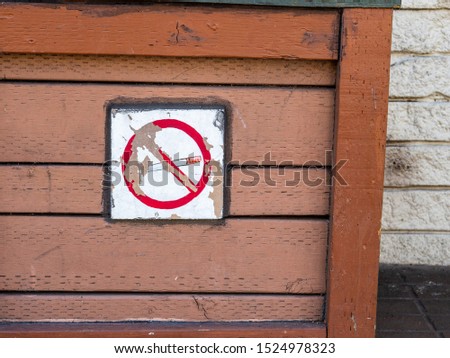 Weathers and peeling no smoking cross out sign of a cigarette
