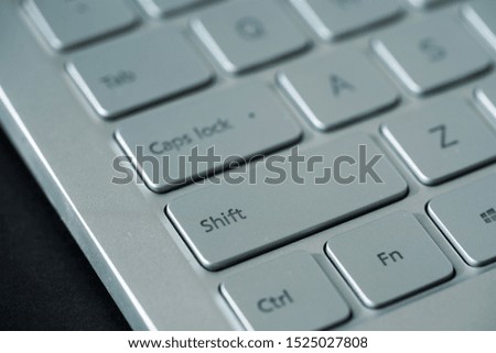 Close up view on Shift button on silver keyboard