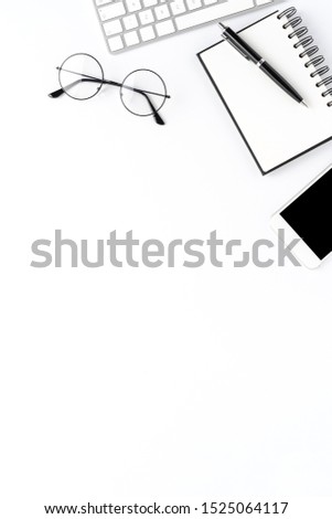 Office desktop with accessories on white table. Business background with copyspace