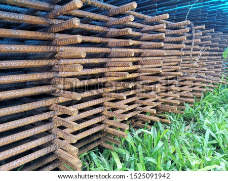 A stack of reinforcement bars secured with metal wires for storage. 
